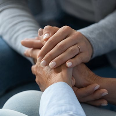 A woman holding hand of another woman